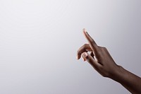 Woman’s finger pointing on gray border background