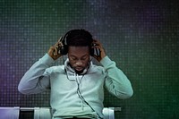 African American man putting on headphones at the subway