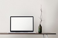 Laptop with blank screen on a desk minimal home office zone design