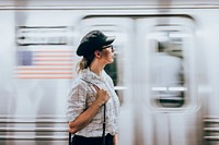 Traveller at subway platform, white tone filter
