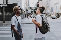 Men standing while chatting with each other in the city