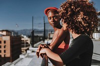 Women hanging out at rooftop balcony in the city