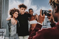 Friends taking photos at rooftop, urban portrait in the city