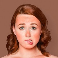 Sunburnt woman face portrait, biting her lips