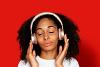 Beautiful woman listening to music through headphones digital device