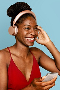 Smiling woman streaming music with smartphone digital device