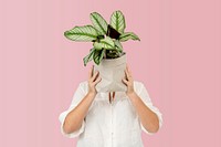 Woman holding potted plant in sustainable packaging
