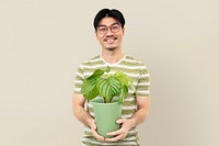 Asian man holding potted houseplant