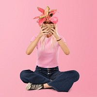 Asian woman holding potted aglaonema plant