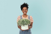 Happy plant parent holding potted shrubs