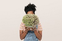 African American plant parent holding potted shrubs