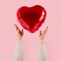 Valentines heart balloon held by a person