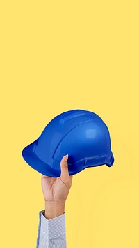 Engineer hard hat held by a hand jobs and career campaign