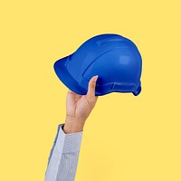 Engineer hard hat held by a hand jobs and career campaign