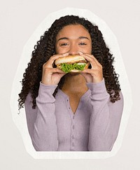 Happy woman eating a hamburger