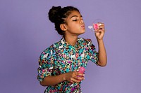 African American girl blowing soap bubbles