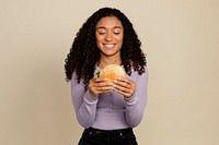 Happy woman eating a hamburger