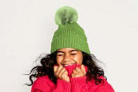 Cute girl in knitted hat, isolated on off white