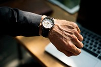 Businessman looking at his watch closeup