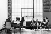 People brainstorming in a workplace, black and white photo