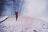 A woman in a red coat looking through binoculars on a snow-covered meadow. Original public domain image from <a href="https://commons.wikimedia.org/wiki/File:Snowy_meadow_through_binoculars_(Unsplash).jpg" target="_blank" rel="noopener noreferrer nofollow">Wikimedia Commons</a>