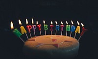 A birthday cake with candles that spell out Happy Birthday. Original public domain image from <a href="https://commons.wikimedia.org/wiki/File:Birthday_Cake_with_Candles_(Unsplash_M20ylqCzSZw).jpg" target="_blank" rel="noopener noreferrer nofollow">Wikimedia Commons</a>