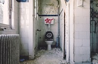 An abandoned bathroom with graffiti. Original public domain image from Wikimedia Commons