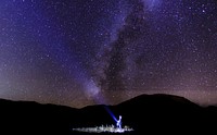 Flashlight towards starry night sky. Original public domain image from Wikimedia Commons