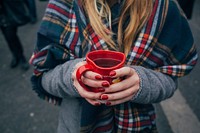 A woman in a scarf holding a red heart-shaped cup with hot tea. Original public domain image from <a href="https://commons.wikimedia.org/wiki/File:Warming_up_in_the_cold_(Unsplash).jpg" target="_blank" rel="noopener noreferrer nofollow">Wikimedia Commons</a>