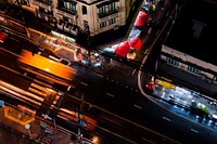 A bird's eye view taken by drone, showing the quiet night-time traffic on a road in Bangkok. Original public domain image from <a href="https://commons.wikimedia.org/wiki/File:Drone_view_of_Bangkok_at_night_(Unsplash).jpg" target="_blank" rel="noopener noreferrer nofollow">Wikimedia Commons</a>