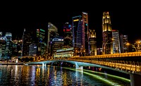 River in a light up urban city during nighttime.<br /><br />Original public domain image from <a href="https://commons.wikimedia.org/wiki/File:Singapore_night_(Unsplash).jpg" target="_blank">Wikimedia Commons</a>
