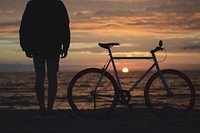 Bike at beach sunset, man. Original public domain image from Wikimedia Commons