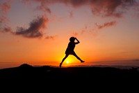 Girl jumping in front of sunset. Original public domain image from Wikimedia Commons