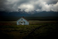 A house on a field during evening.Original public domain image from Wikimedia Commons