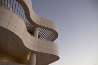 The exterior of white tiled terraces in the top part of a building. Original public domain image from Wikimedia Commons