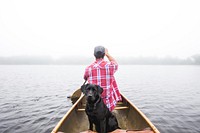 Labrador dog takes a boat ride with its owner on a calm lake. Original public domain image from <a href="https://commons.wikimedia.org/wiki/File:Dog_Adventures_in_Nature_(Unsplash).jpg" target="_blank" rel="noopener noreferrer nofollow">Wikimedia Commons</a>