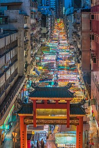 A window view of a long colorful street market in an Asian city. Original public domain image from Wikimedia Commons