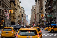 Taxi cabs stop at a red light at a busy intersection in downtown Manhattan. Original public domain image from Wikimedia Commons