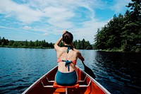 Woman kayaking photo, public domain travel image. Original public domain image from Wikimedia Commons