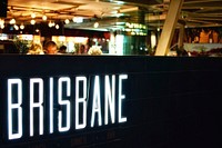 A bright white “Brisbane” neon in a club. Original public domain image from <a href="https://commons.wikimedia.org/wiki/File:White_Brisbane_neon_(Unsplash).jpg" target="_blank" rel="noopener noreferrer nofollow">Wikimedia Commons</a>