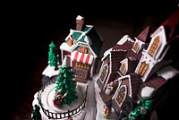 A model of the Christmas holiday replete with church, Christmas tree, snowman, house and people. Original public domain image from Wikimedia Commons