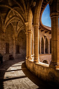 Antique European architecture with arched corridor. Original public domain image from <a href="https://commons.wikimedia.org/wiki/File:Castell_de_Bellver_(Unsplash).jpg" target="_blank">Wikimedia Commons</a>