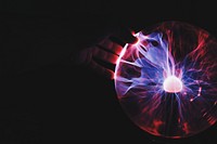 A hand touching lighting orb. Original public domain image from Wikimedia Commons