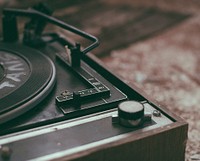 An old and broken, vintage black turntable. Original public domain image from <a href="https://commons.wikimedia.org/wiki/File:Frequencies_lost_in_the_fire_(Unsplash).jpg" target="_blank">Wikimedia Commons</a>