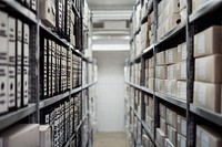 Binders and boxes on shelves in a large archive. Original public domain image from Wikimedia Commons