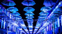 Hanging decoration of blue umbrellas in Poland.. Original public domain image from <a href="https://commons.wikimedia.org/wiki/File:Light_Festival_(Unsplash).jpg" target="_blank" rel="noopener noreferrer nofollow">Wikimedia Commons</a>
