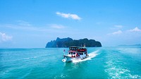 A group of tourists on a cruise boat sailing through the azure ocean. Original public domain image from <a href="https://commons.wikimedia.org/wiki/File:Boat_cruise_in_Phang-nga_(Unsplash).jpg" target="_blank" rel="noopener noreferrer nofollow">Wikimedia Commons</a>