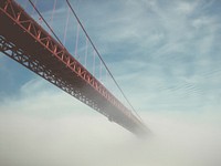 Golden Gate Bridge disappears into the cloudy fog. Original public domain image from Wikimedia Commons