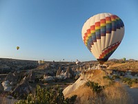 Hot air balloons launch off a deserted landscape. Original public domain image from <a href="https://commons.wikimedia.org/wiki/File:Hot_Air_Balloon_Launch_(Unsplash).jpg" target="_blank" rel="noopener noreferrer nofollow">Wikimedia Commons</a>