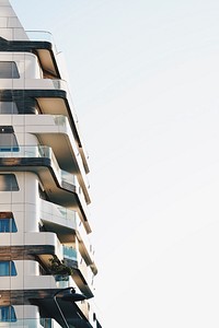 Building with modern architecture and balconies with clear sky and windows in Milan. Original public domain image from Wikimedia Commons